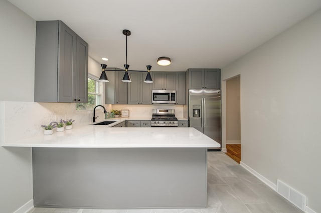 1770 Henley St Unit C, Glenview, IL 60025 - kitchen with appliances with stainless steel finishes, a sink, gray cabinets, a peninsula, and baseboards