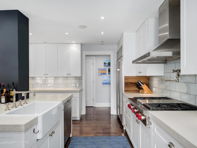 3920 N Lake Shore Dr Unit 12N, Chicago, IL 60613 - kitchen with wall chimney range hood, appliances with stainless steel finishes, light countertops, recessed lighting, and white cabinets