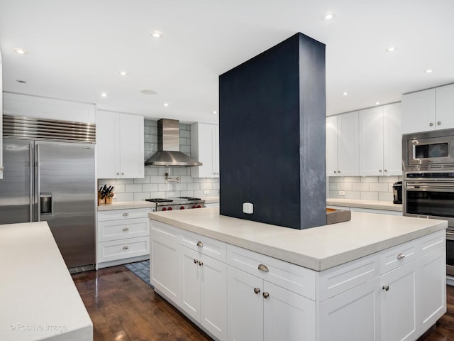 3920 N Lake Shore Dr Unit 12N, Chicago, IL 60613 - kitchen featuring built in appliances, wall chimney range hood, a center island, backsplash, and light countertops