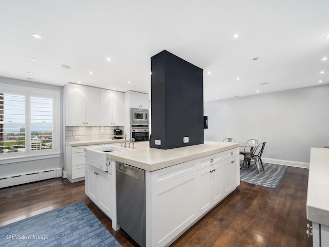 3920 N Lake Shore Dr Unit 12N, Chicago, IL 60613 - kitchen with appliances with stainless steel finishes, dark wood-style flooring, a center island with sink, a baseboard heating unit, and recessed lighting