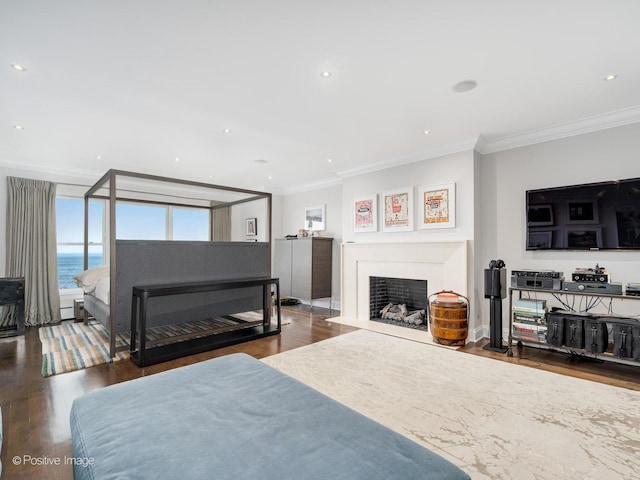 3920 N Lake Shore Dr Unit 12N, Chicago, IL 60613 - bedroom with ornamental molding, wood finished floors, a fireplace with flush hearth, a water view, and recessed lighting