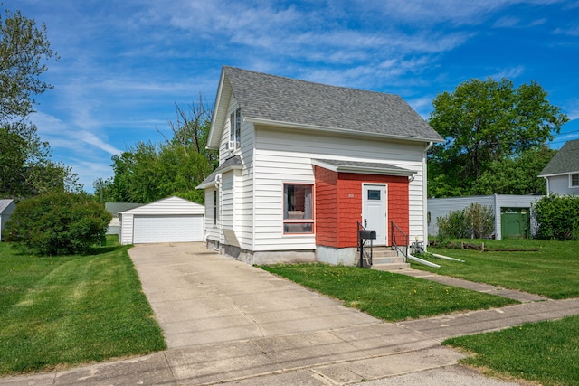 1415 Union Ave, Belvidere, IL 61008 - view of front of home featuring entry steps, an outbuilding, a front yard, a garage, and a shingled roof