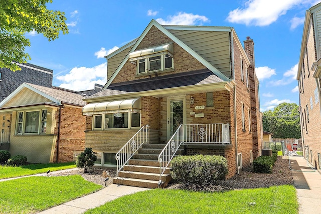 3840 S Wolcott Ave, Chicago, IL 60609 - view of front of house featuring brick siding, a front lawn, a shingled roof, a porch, and a chimney