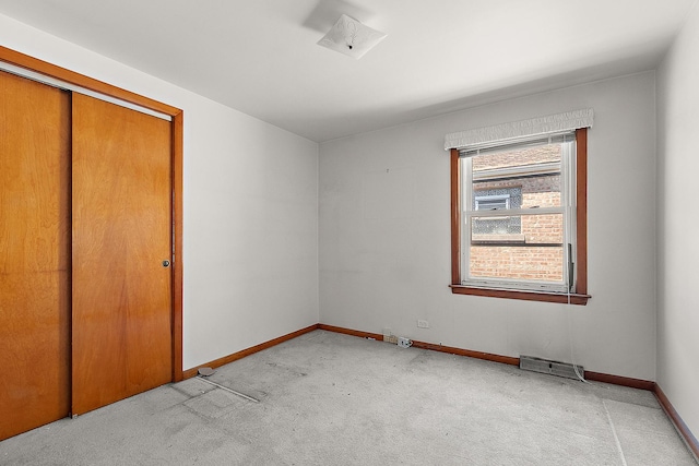 3840 S Wolcott Ave, Chicago, IL 60609 - unfurnished bedroom with light carpet, baseboards, and a closet
