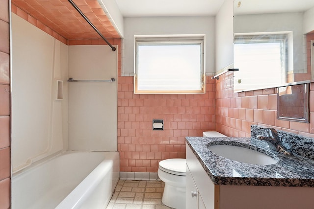 3840 S Wolcott Ave, Chicago, IL 60609 - full bath with toilet, vanity, shower / bathtub combination, tile walls, and a wainscoted wall