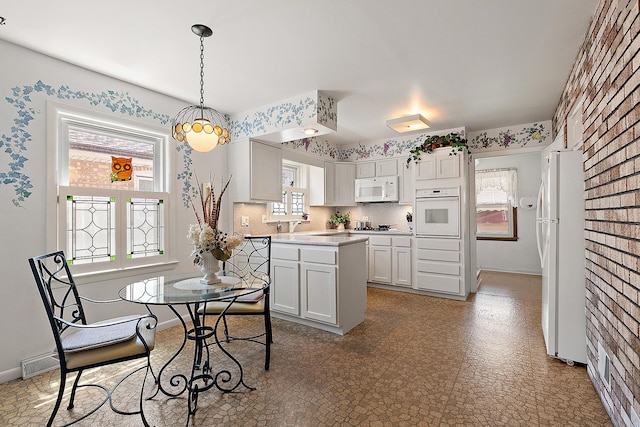 3840 S Wolcott Ave, Chicago, IL 60609 - kitchen featuring white appliances, baseboards, light countertops, pendant lighting, and tile patterned floors