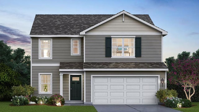 traditional-style house featuring a garage, a shingled roof, driveway, and a yard