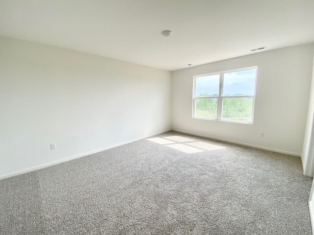 carpeted spare room with baseboards