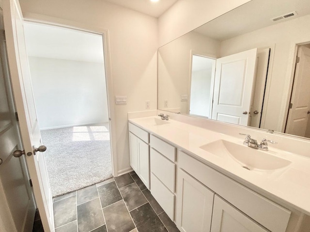 full bathroom featuring double vanity and baseboards