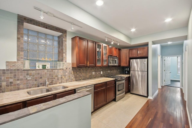 1830 W 18th St, Chicago, IL 60608 - kitchen with appliances with stainless steel finishes, a sink, rail lighting, light stone counters, and glass insert cabinets
