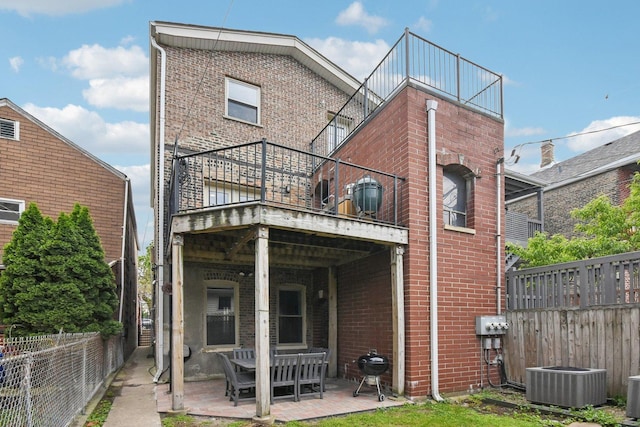 1830 W 18th St, Chicago, IL 60608 - back of property with brick siding, cooling unit, and a patio