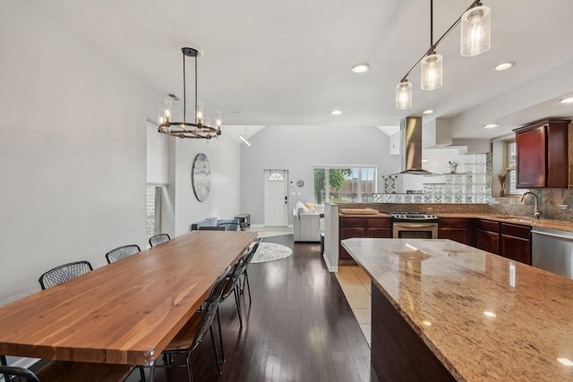 1830 W 18th St, Chicago, IL 60608 - kitchen featuring appliances with stainless steel finishes, island exhaust hood, a sink, tasteful backsplash, and light stone countertops