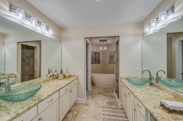2105 Lillian Ln, Lisle, IL 60532 - bathroom featuring two vanities, a soaking tub, a tile shower, baseboards, and a chandelier