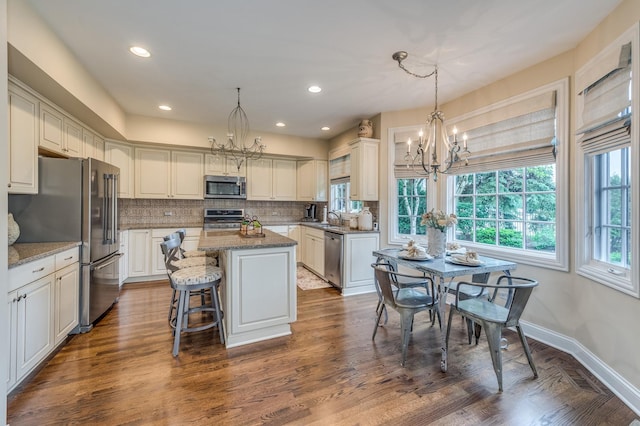 2105 Lillian Ln, Lisle, IL 60532 - kitchen with stainless steel appliances, a sink, a chandelier, a center island, and backsplash
