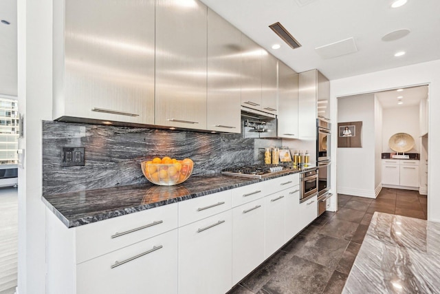 600 N Kingsbury Ave Unit 506, Chicago, IL 60610 - kitchen with decorative backsplash, appliances with stainless steel finishes, recessed lighting, modern cabinets, and dark stone counters