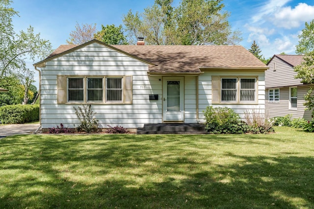 711 Parkside Dr, Rockford, IL 61108 - bungalow-style home featuring a chimney, a front yard, and a shingled roof