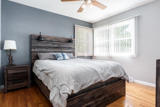 711 Parkside Dr, Rockford, IL 61108 - bedroom with baseboards, wood finished floors, and ceiling fan