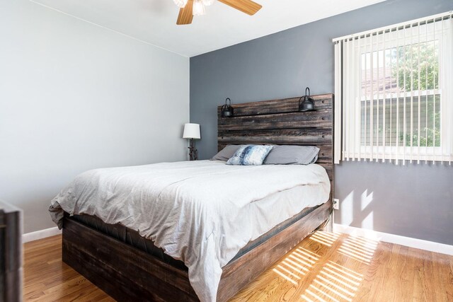 711 Parkside Dr, Rockford, IL 61108 - bedroom with baseboards, wood finished floors, and a ceiling fan