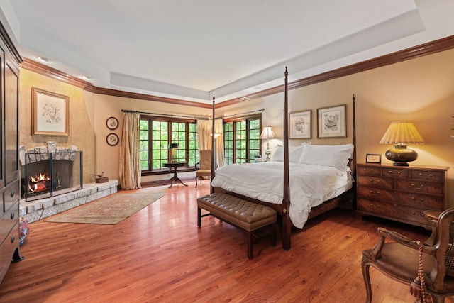 38W250 Burr Road Ln, Saint Charles, IL 60175 - bedroom featuring a tray ceiling, crown molding, wood finished floors, and a fireplace