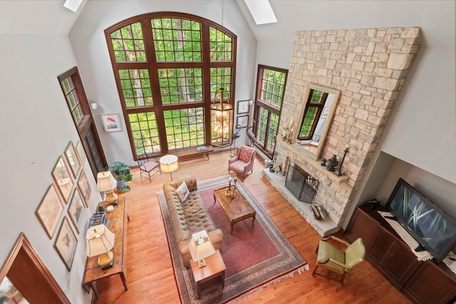 38W250 Burr Road Ln, Saint Charles, IL 60175 - living room featuring a skylight, high vaulted ceiling, wood finished floors, and a fireplace