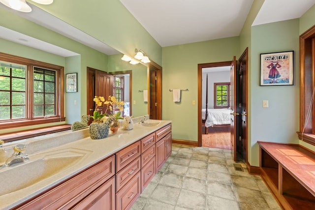38W250 Burr Road Ln, Saint Charles, IL 60175 - ensuite bathroom featuring double vanity, baseboards, and stone finish flooring