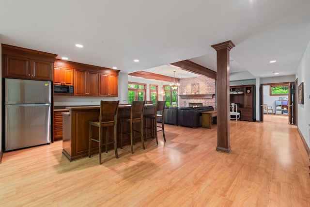 38W250 Burr Road Ln, Saint Charles, IL 60175 - kitchen with freestanding refrigerator, black microwave, light wood-style floors, a kitchen bar, and recessed lighting