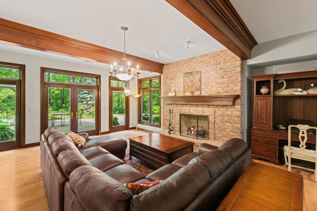 38W250 Burr Road Ln, Saint Charles, IL 60175 - living area featuring light wood-style flooring, a fireplace, a chandelier, and baseboards
