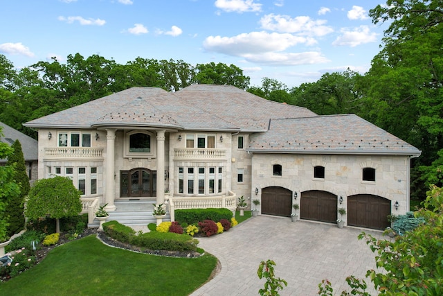 115 Carmela Ct, Bloomingdale, IL 60108 - view of front facade featuring a high end roof, french doors, stone siding, an attached garage, and a balcony