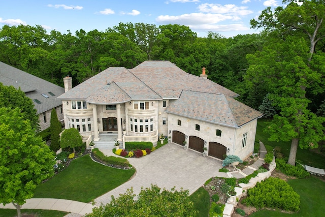 115 Carmela Ct, Bloomingdale, IL 60108 - view of front of property with a high end roof, a chimney, decorative driveway, and stone siding
