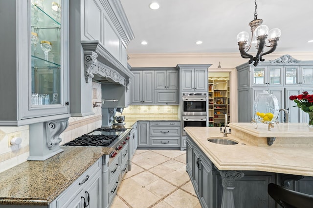 115 Carmela Ct, Bloomingdale, IL 60108 - kitchen featuring gray cabinetry, appliances with stainless steel finishes, a sink, decorative backsplash, and light stone countertops