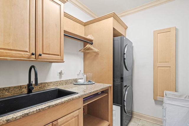115 Carmela Ct, Bloomingdale, IL 60108 - washroom with stacked washer and clothes dryer, ornamental molding, light tile patterned floors, cabinet space, and baseboards