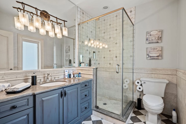 115 Carmela Ct, Bloomingdale, IL 60108 - full bath with vanity, a shower stall, tile walls, toilet, and tile patterned floors