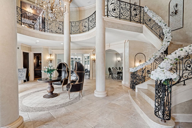115 Carmela Ct, Bloomingdale, IL 60108 - entryway with a high ceiling, crown molding, arched walkways, stairs, and ornate columns