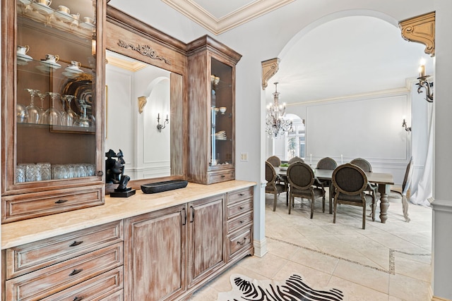 115 Carmela Ct, Bloomingdale, IL 60108 - bar with arched walkways, ornamental molding, light tile patterned floors, and a chandelier