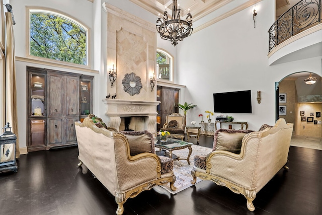 115 Carmela Ct, Bloomingdale, IL 60108 - living room with a towering ceiling, a fireplace, arched walkways, crown molding, and a chandelier