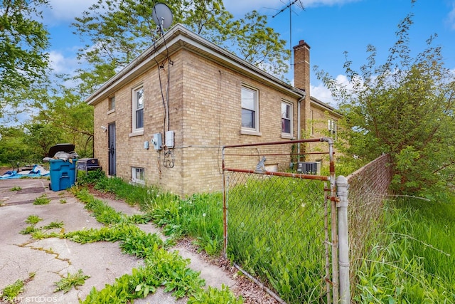 14301 S Halsted St, Riverdale, IL 60827 - view of property exterior with a chimney, brick siding, and central air condition unit
