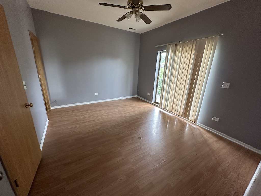 4139 W Gladys Ave, Chicago, IL 60624 - empty room with a ceiling fan, wood finished floors, and baseboards