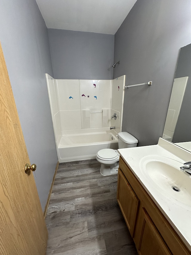 4139 W Gladys Ave, Chicago, IL 60624 - bathroom featuring toilet, vanity, shower / bath combination, and wood finished floors