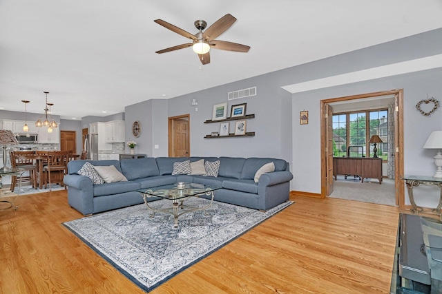 507 Cambridge Ln, Shorewood, IL 60404 - living area featuring light wood-style floors, ceiling fan, and a chandelier