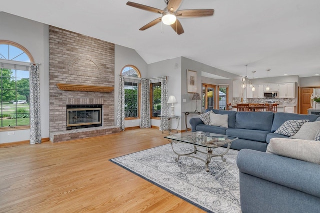 507 Cambridge Ln, Shorewood, IL 60404 - living area with a ceiling fan, light wood finished floors, a brick fireplace, and high vaulted ceiling