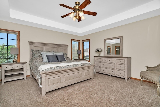 507 Cambridge Ln, Shorewood, IL 60404 - bedroom with light carpet, a tray ceiling, and ceiling fan