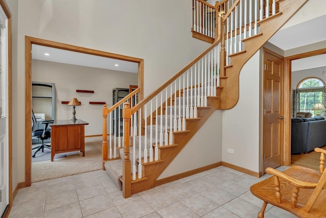 507 Cambridge Ln, Shorewood, IL 60404 - stairway featuring tile patterned floors, a high ceiling, carpet flooring, and recessed lighting