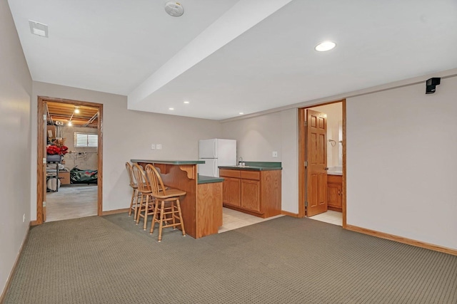 507 Cambridge Ln, Shorewood, IL 60404 - kitchen with freestanding refrigerator, a breakfast bar, light carpet, a peninsula, and recessed lighting