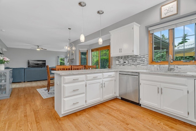 507 Cambridge Ln, Shorewood, IL 60404 - kitchen featuring stainless steel dishwasher, a peninsula, ceiling fan, white cabinetry, and decorative backsplash