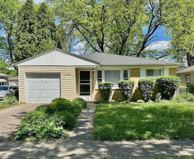 319 Triggs Ave, Elgin, IL 60123 - ranch-style house featuring a garage, asphalt driveway, and brick siding