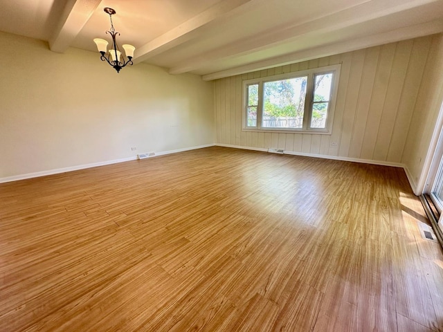 319 Triggs Ave, Elgin, IL 60123 - spare room featuring wood finished floors, a chandelier, and beamed ceiling