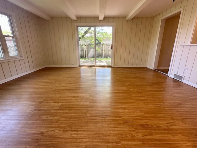 319 Triggs Ave, Elgin, IL 60123 - spare room featuring beamed ceiling, wood finished floors, and wood walls
