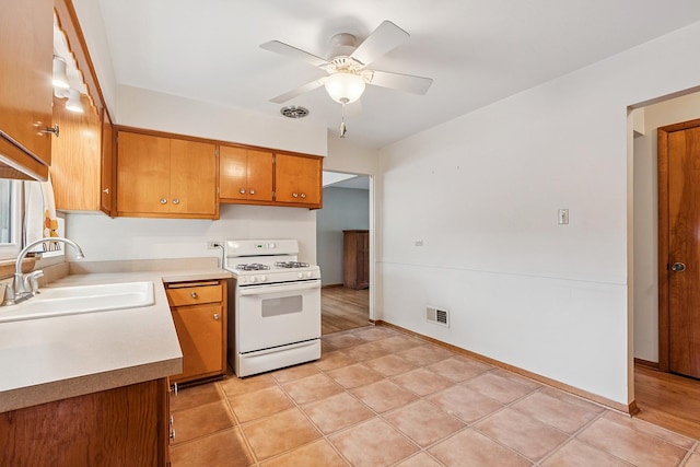 3918 213th Pl, Matteson, IL 60443 - kitchen with gas range gas stove, a sink, brown cabinets, light countertops, and a ceiling fan