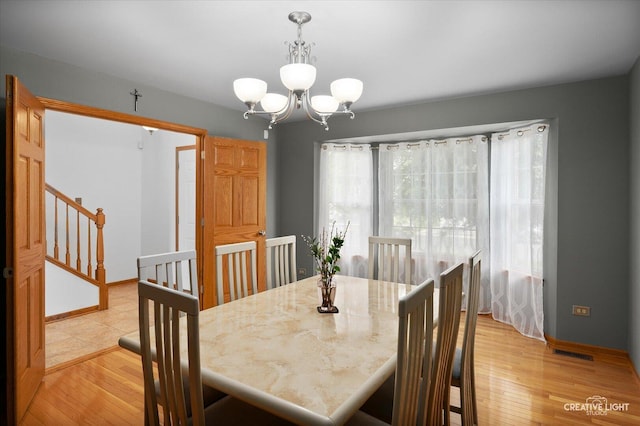 2912 Indian Springs Ct, Joliet, IL 60435 - dining space with a chandelier, baseboards, and light wood finished floors