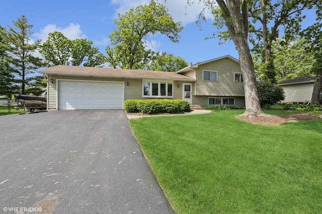 7404 Wooded Shore Dr, Wonder Lake, IL 60097 - split level home with a front lawn, driveway, and an attached garage